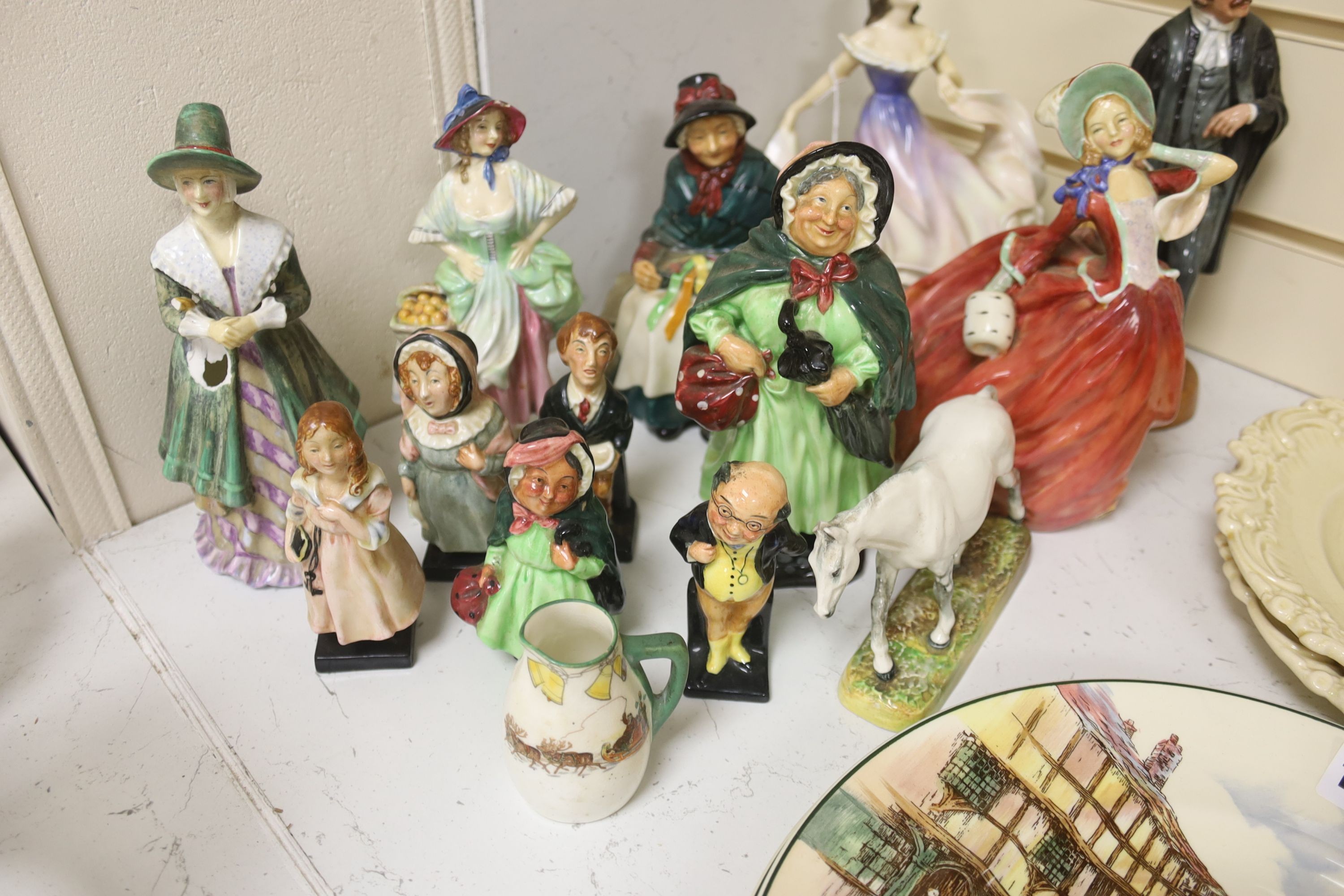 A group of 12 Royal Doulton figures and four plates